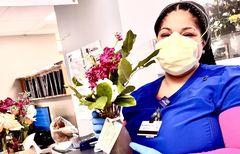Wedding Idea of Nurse Holding Donated Flowers